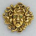 Sculpted gold medusa head and serpent brooch ca 1900 gustav manz attr in 14k with green garnet eyes pendant hook on reverse 473 dwt 11 gs 1 18 x 1 18