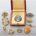 Collection of gold or silver jewelry 18801930 bloomed gold and conch cameo brooch reverse painted crystal intaglio gold brooch depicts cardinal trout fly specimen under shaped crystal and gold st