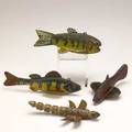 Fish decoys three in painted wood with metal fins together with a dragonfly all 20th c longest 7 14