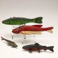 Fish decoys four in painted wood with metal fins 20th c longest 9 14