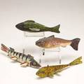 Fish decoys four in painted wood with metal fins 20th c longest 7 12