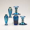 Steuben pair of blue aurene candlesticks together with three bud vases 20th c candlesticks marked tallest 4 34