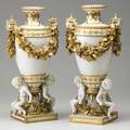 Pair of porcelain figural urns gilded rope decoration and cherub supports late 19th c stamped r 17 12 x 9 12