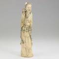 Chinese ivory figure carved flower seller with display of various blooms 20th c signed 14 14