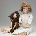 German bisque head dolls two with costume early 20th c one marked jdk214 the other sh 1909 tallest 24