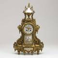 Louis xv clock gilt metal with inset porcelain panels and face 19th c marked ad mougin 20 12 x 12 x 5