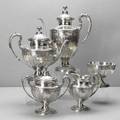 Redlich  co ornate silver coffee service ca 1900 5 footed pieces with chased repousse floral and scroll panels acanthus borders handles and spout flower basket finials coffee pot 10 14