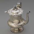 Double walled coin silver hot chocolate pot ca 1850 flaredfooted form side handle and low tapering spout with chased foliate decoration applied floral scrolling rim and blossom finial hot wate