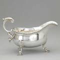 English silver gravy pitcher by william gibson and john langman london 1895 bulbous on three scroll and shell feet scroll handle applied reed edge chased griffon 13 ot 8 beyond handle