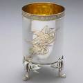 Tiffany  co japanesque parcel gilt vase ca 1874 cylindrical form on bamboo branch and foliage feet one side depicts gilt cranes in flight the reverse with blossoming cherry branches above catta