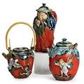 Sumida gawa pottery three pots with figures in relief on red ground early 20th c chocolate pot with figural head teapot with figures in relief and covered pot with pouring spout all marked tall