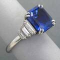 Untreated sapphire diamond and platinum ring rectangular emerald cut sapphire 107 x 1018 x 713 mm approx 75 cts  flanked by six graduated baguette diamonds approx 75 ct tw size 5 12