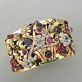 Jeweled gold tutti fruitti giardinetto cuff 14k pink gold hinged cuff with applied multicolored gold basket and foliage with carved and shaped rubies and sapphires diamond and emerald accents diam