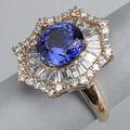 Tanzanite and diamond dinner ring ca 1980 faceted circular cut tanzanite 40 cts by formula within a radial frame of tapered baguette cut diamonds and scalloped surround of circular brilliant cut