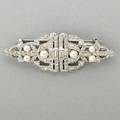 Art deco diamond pearl clipbrooch shieldshaped open platinum clips set with circular baguette and marquiseshaped diamonds approx 250 cts tw spherical pearls white gold brooch fittings and b