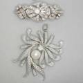 Two white gold diamond brooches stylized floral spray with cultured pearl hinged pendant bail 1 34 x 1 38 pearshaped cluster and ribbon open panel 1 58 largest diamond 33 ct diamonds a