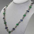 Patinated jeweled elizabethan style necklace cabochon cut blue kyanites and green gems in dogtooth bezels join patinated diamond scroll links in 18k gold diamonds 3 cts tw 407 dwt 633 gs