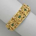 18k gold jeweled bracelet italy 20th c chased foliate openwork panels set with diamond and emerald accents 347 dwt 54 gs 6 34 x 1 58