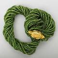 Hawks heads gold nephrite torsade ca 1975 18k yg hawks heads clasp with ruby or emerald eyes joins fifteen strands of nephrite beads unmarked clasp 2 x 1 necklace 25 14