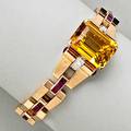Tiffany  co jeweled gold bracelet ca 1942 emerald cut citrine 188 x 142 mm and diamond strapped tubular shoulders with ruby cabochon terminals finished by geometric gold and calibrated ruby li