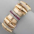 Retro bicolor gold flip watch ca 1948 geometric yellow gold links with white gold trim the hinged watch cover designed as a stylized bow with rows of rubies and diamonds weighed without swiss 17