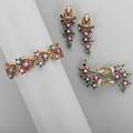 Precious gem floral gold parure link bracelet brooch and clip earrings designed as ruby or sapphire flower heads with diamonds and emerald leaves on 18k yg cords fine brilliant cut diamonds appr