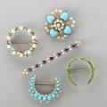 Five 14k gold jeweled brooches ca 1900 diamond and pearl wreath with demantoid garnets demantoid horseshoe diamond turquoise crescent turquoise pearl and diamond quatrefoil sapphire and pearl
