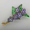 Enameled gold diamond bouquet brooch ca 1895 rose cut diamonds in silver veins on translucent enamel leaves support five purple shaded violets with omc diamond centers oval tag mark for tiffany 