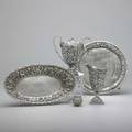 Silver repousse holloware 18681907 four items by s kirk  son cream and sugar service tea strainer clawfooted salver with quilted ground baltimore silversmiths mfg co open vegetable bowl wi