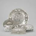 Continental silver accessories five pieces with embossed cherub motifs fanshaped hinged casket cushionshaped hinged casket cigarette case oval bonbon dish with reticulated edge shallow bowl wi