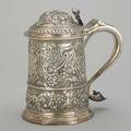 Silver repousse covered tankard barrelshaped above ring foot bands and dome lid of floral rococo decorations and gadroon earshaped handle with heart terminus inscribed on foot a token of regard