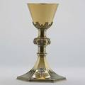 Tiffany  co jewelred silvergilt chalice 1919 in the gothic style hexagonal knopped column and hexagonal flared foot set with garnets amethysts rose cut diamonds and pastes presentational insc