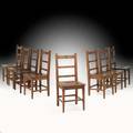 Roycroft assembled group of eight chestnut or oak ladderback side chairs east aurora ny ca 1905 carved orb and cross marks on seat or crest rails 36 34 x 16 34 x 16 14 provenance rago a