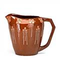 Jervis pitcher excised and enameldecorated with stylized blossoms and tulips in pink and white on a rich brown ground vertical mark 6 12 x 8 12