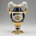 Meissen porcelain urn with floral reserves gilded highlights and snake handles on cobalt ground 20th c crossed swords mark 15