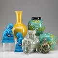 Asian decorative group seven items 19th20th c pair of pottery foo dogs pair of porcelain ginger jars celadon elephant planter pliqueajour floral vase and porcelain vase with incised decorati