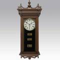 Waterbury calendar wall clock keating model with walnut case and time and strike movement late 19th c 37 x 15 58 x 9 14