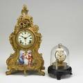 Ansonia mantle clock gilt metal in the french style with porcelain panel and time and strike movement late 19th c together with novelty globe clock under glass dome patent date 1856 ansonia 14