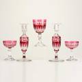 Cranberry glass approximately twentyseven cut glass pieces eleven water goblets fourteen sherbets and pair of candlesticks probably bohemian unmarked goblets 6 58