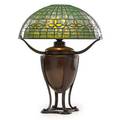 Tiffany studios table lamp with fleur de lys shade new york 1900s leaded glass patinated bronze single socket shade stamped tiffany studios new york 143724 base of converted font with raised