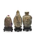 Chinese rock crystal snuff bottles three with relief decoration and bases 19th c tallest 3 34 with base