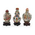 Chinese porcelain snuff bottles three with relief decoration lids and bases 19th c taller 3 with base
