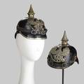 German pickelhaube two in leather one with brass mountings the other tin early 20th c brass mounted marked kbag 1915 on brim each 8 12 x 6 x 9