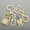 Two pieces ivory jewelry ca 1960 carved elephant pendant with diamond eye trimmed with turquoise and lapis in 14k yg 3 34 chinese carved ivory mask 4 on strand of ivory beads  internatio