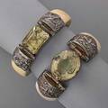 Two hinged ivory and silver citrine cuffs ivory with decorative hinges of silver each set with large faceted citrine 2 58 x 1 34 and 2 x 2 12  international bids and bids issuing from the