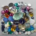 Collection of assorted unmounted gemstones approx 530 cts includes but not limited to ruby sapphire opal aquamarine kunzite amethyst in faceted and cabochon cuts includes 78 cts green beryl