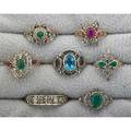 Seven dress rings with diamonds late 20th c victorian style includes but not limited to blue topaz emerald ruby some silver some gold some silver toppedgold 154 dwt gw sizes 68