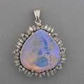 Crystal opal and diamond pendantbrooch spadeshaped opal approx 17 cts in closed back setting surrounded by circular and baguette cut diamonds approx 1 cts tw 87 dwt at least 10k gold 1