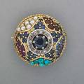 Jeweled 18k gold bombe brooch ca 1955 circular faceted sapphire framed by diamonds and surrounded by sapphires rubies pearls and turquoise petit point in star design 56 dwt 78 x 12
