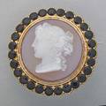 Victorian 14k gold cameo mourning brooch 1835 round hardstone cameo depicts female profile framed by circular faceted black gems the reverse with memorial inscription to js mckim hinged bail 1